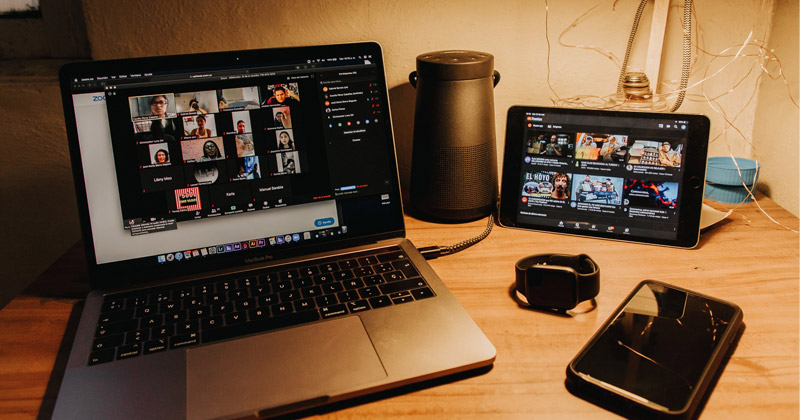 Laptop on a desk with a virtual meeting on screen